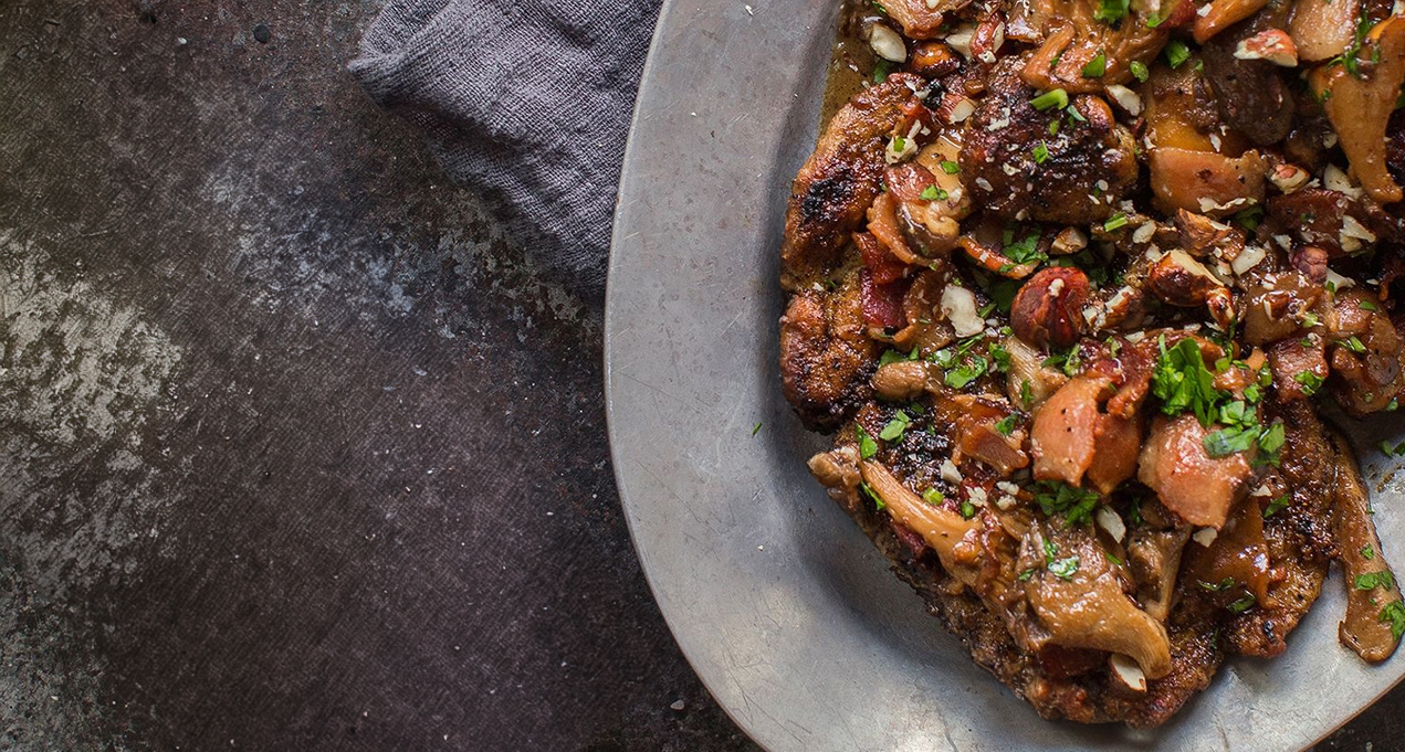 A bowl of chicken marsala and a bottle of WillaKenzie Pinot Noir